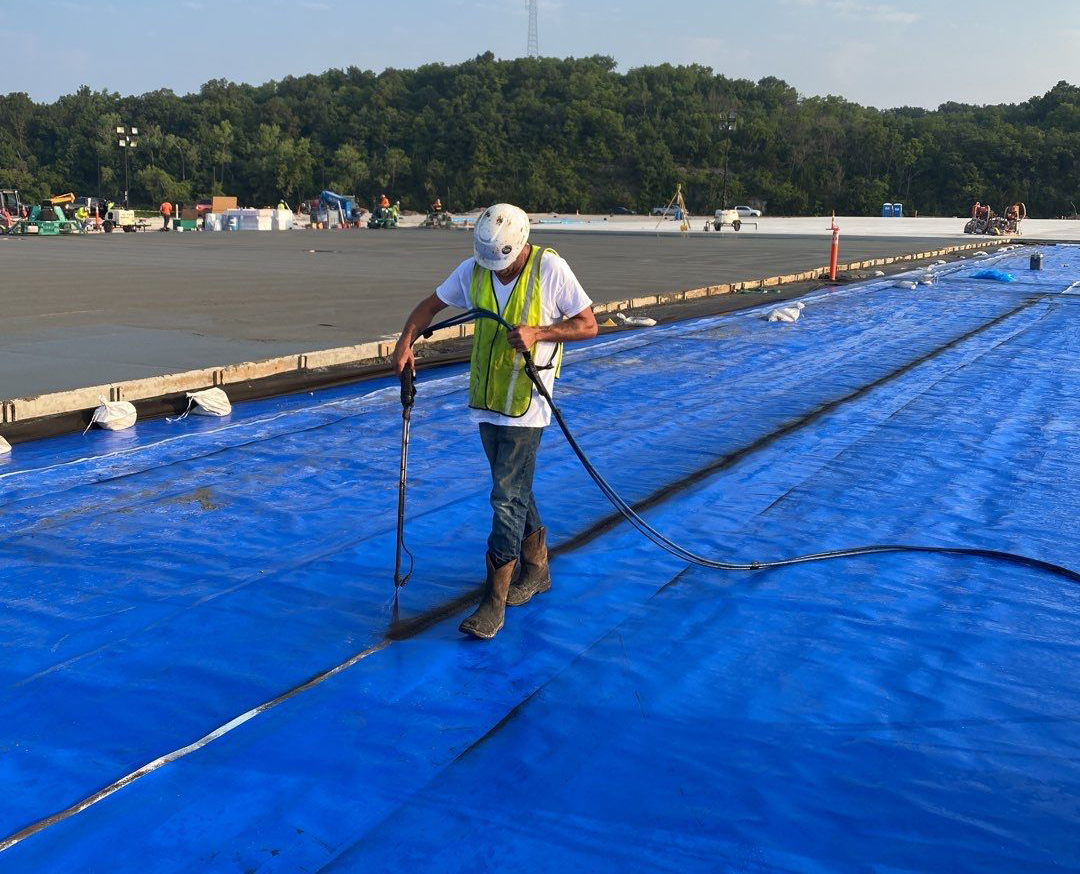 Sheet membrane with spray-applied seams.